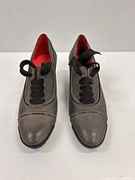 Front view of the taupe nubuck suede lace-up wedge oxford shoes showing toe shape, stitching, laces and red lining