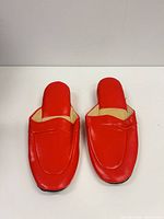 Top view of red mule slippers showing upper and insole