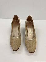 Front top view of both gold metallic pumps