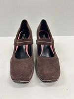 Front view of both brown suede Mary Jane pumps showing square toes and adjustable straps