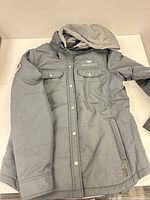 Front view of gray hooded jacket laid flat