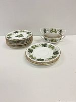 Stacks of plates and two stacked bouillon cups showing pattern