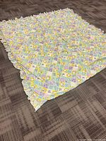 Quilt laid flat showing full size and ruffled edges