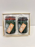 Two green porcelain yunomi cups with lids inside box