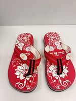 Top view of pair showing floral print and brand logo on insoles