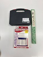 Closed black carrying case, brace box and back scratcher box