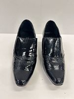 Front view of pair showing patent finish and pointed toes