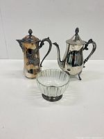 Full lot view showing both silver-plated pots and glass bowl on base