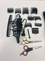 All items laid out showing clipper, guards, comb, scissors, thinning shears, brush