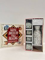 Front view of boxed sake set and book front cover
