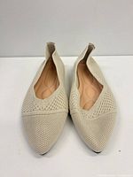 Top view of both flats showing knit material, pointed toes, insoles