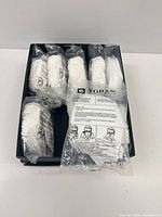Tray containing ten individually plastic-wrapped packs of white KN95 masks
