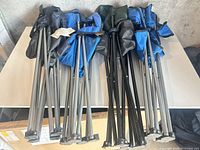 Multiple folded camping chairs showing frames and fabric