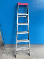 Full view of 6-ft aluminum step ladder with red top