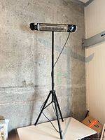 Full view of heater on tripod stand
