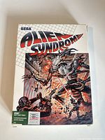 Front of Alien Syndrome Atari box showing Sega branding and cover art