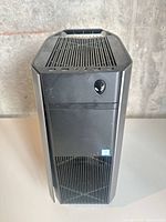 Front view showing Alienware logo, optical bay cover, Intel sticker and ventilation grill