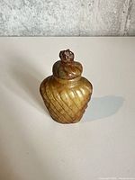 Front view of carved stone snuff bottle and stopper