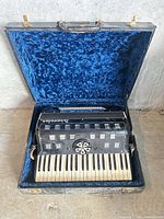 Accordion in open blue-lined hard case