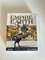 Front view of sealed Empire Earth PC game box