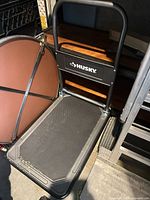 Full view of Husky folding flat dolly showing platform, handle and logo