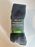 Rolled pair of Kirkland merino wool blend socks in original packaging