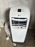 Front view of LG portable AC with exhaust hose and power cord