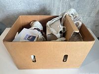 Overall view of cardboard box with packed items