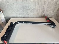 Side view of SportRack hitch-mount bike rack arm with reflectors