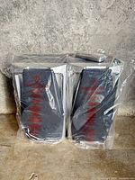 Front view of both speakers still sealed in plastic