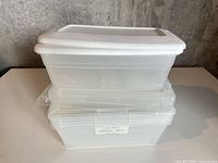 Stacked view of three clear plastic containers showing lids and overall condition