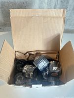 Open cardboard box showing multiple shrink-wrapped Uline thermal ribbon rolls
