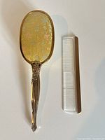 Front view of hairbrush and comb showing overall design