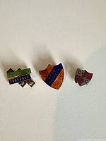 All three enamel pins side by side
