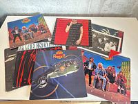 Stack of eight rock vinyl LPs showing visible titles and jacket art