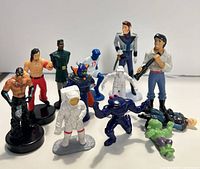 Group shot of all 12 figures standing and lying on surface