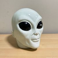 Front view of ceramic alien head coin bank
