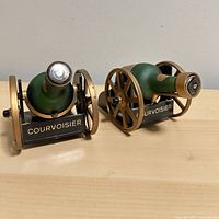 Pair of Courvoisier cannon bottle holders front view