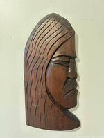 Full view of cedar carved warrior mask showing profile and hair detail
