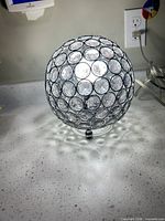 Front view of spherical crystal orb lamp on countertop