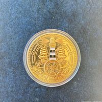 Obverse of medal showing lighthouse, ships and compass rose inside capsule