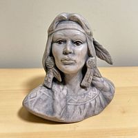 Front view of gray ash bust sculpture