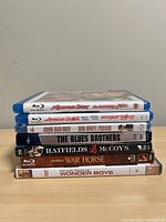 Stack of seven movie cases showing spines with all titles visible