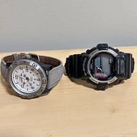 Timex analog and Casio G-Shock digital watches side by side