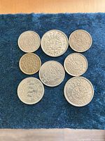 Overhead view of all 8 Macau coins arranged on fabric