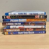 Stacked view of all seven movie cases showing spines and titles
