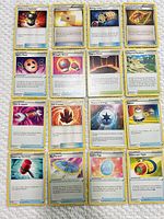 All 16 trainer and energy cards arranged in four-by-four grid