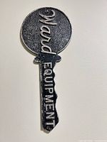 Front view of the cast iron Ward Equipment advertising key