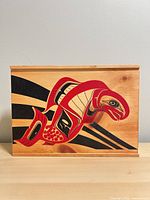 Front view showing full salmon artwork and wood grain