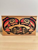 Front view of wooden box showing full Indigenous style artwork and lid